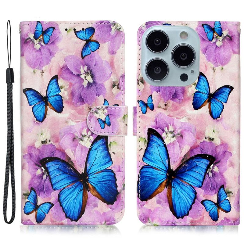Kožený Kryt iPhone 16 Pro Modrí Motýli A Fialové Květiny S Popruhem